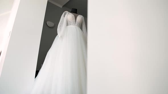 The Wedding Dress Hangs on a Mannequin in the Hotel Room