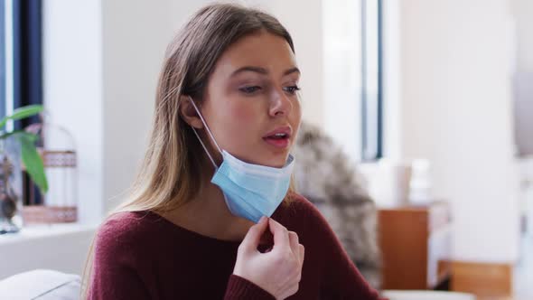 Woman pulling down face mask to breathe