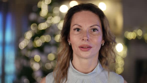 Portrait of a Woman on the Background of a Living Room Decorated for Christmas