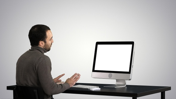 Young business man making video call on his computer on