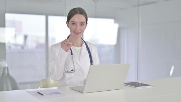 Attractive Young Doctor Doing Call Me Sign with Hand 