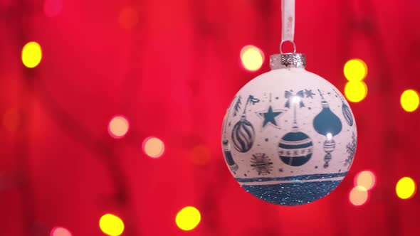 White New Year Ball Toy and Blinking Garland with Round Defocused Lights