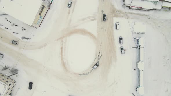 Cars on a City Road Covered with Thick White Snow After a Blizzard