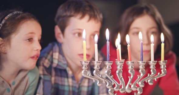 Kids watching hanukka candles burning