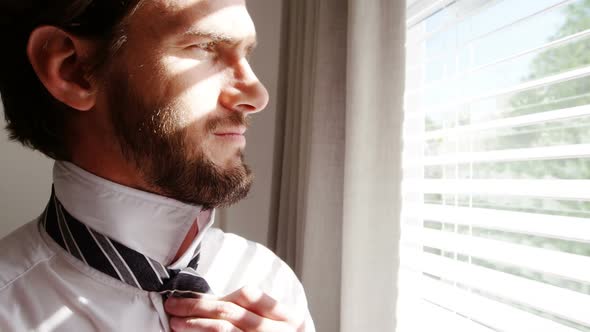 Man getting dressed in bedroom