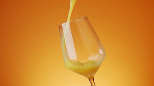 Delicious Orange Juice Poured Into a Glass on a Colored Background