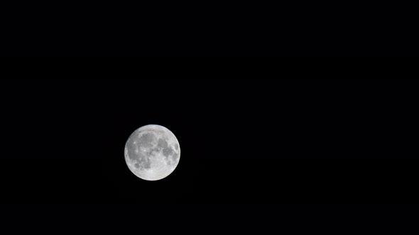 Full Moon Over Dark Black Sky at Night