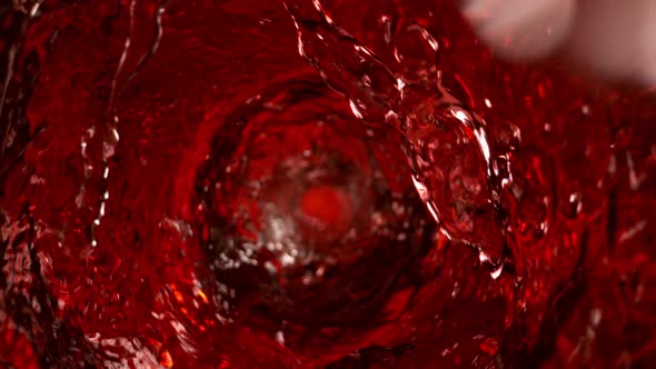 Super Slow Motion Shot of Red Wine Whirling in Glass Bottle at 1000Fps