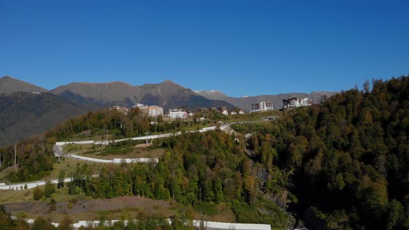 Cars Drive on the Mountain Road Leading to Rosa Khutor Village