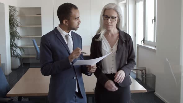Female Professional Showing Report To Boss