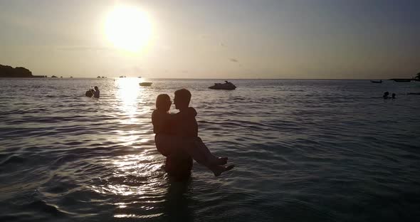 Beautiful lady and man on honeymoon vacation spend quality time on beach on clean white sand 