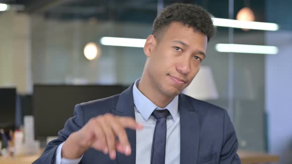 Portrait of Young Businessman Pointing Finger at Camera