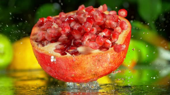 Super Slow Motion Shot of Pomegranate Falling Into Water and Making Splash at 1000Fps