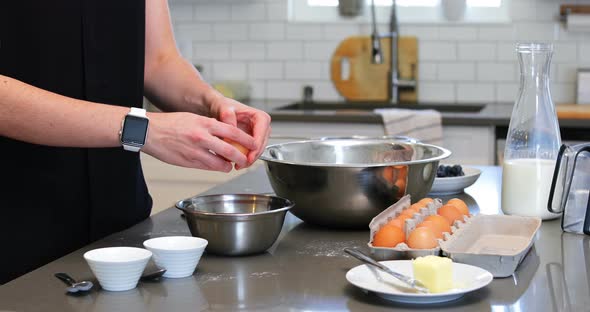 Woman Cracking Egg in A Bowl in Kitchen 4k