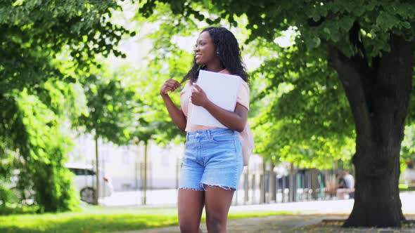 African Student Girl with Notebooks in City