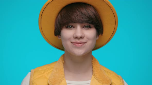 Portrait of Charming Young Woman in Trendy Yellow Hat