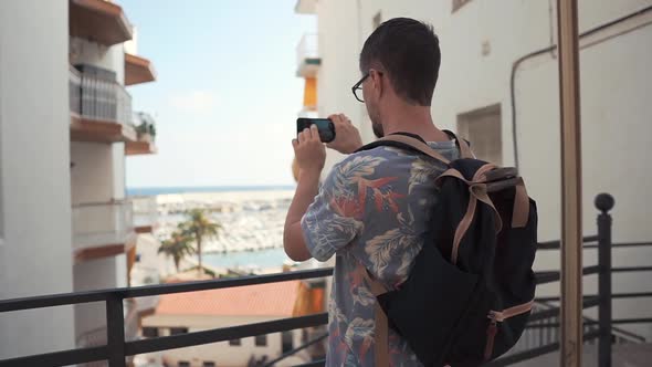 Guy Is Taking Photo of Amazing View From Balcony Using Camera of Mobile Phone