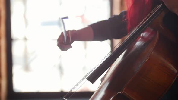 A Woman Playing the Cello in the Studio