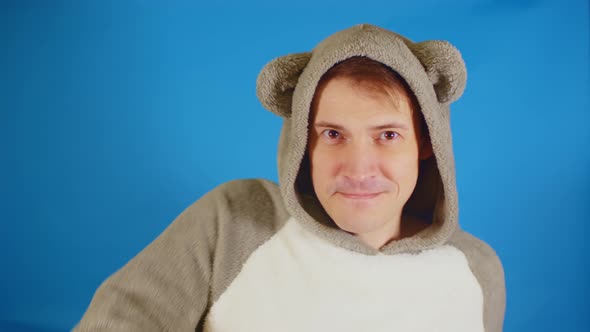 Man in Hoodie with Ears Dancing on Blue Background