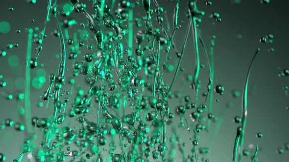 Super Slow Motion Shot of Splashing Oily Green Liquid on Gradient Background at 1000Fps