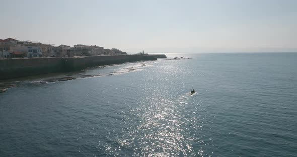 Aerial view of a person doing kayak along the shore, Old City of Acre, Israel.