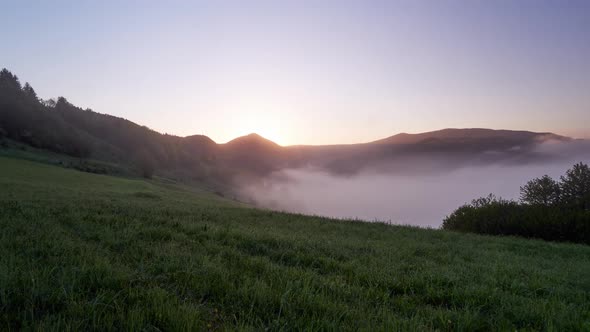 The Rising Sun Floods the Misty Mountain Countryside with Bright Warm Light