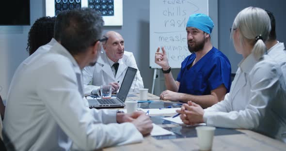 Doctor Making His Colleagues Laugh with Story