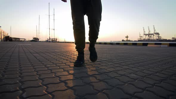 Close Up Shot of Unrecognizable Man Walking Near Sea Port During Sunset Ir Sunrise Slow Motion