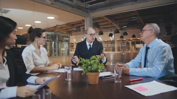 Subordinates Applauding Successful Male Mature Speaker