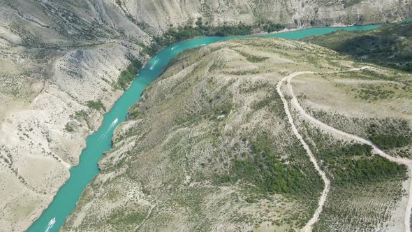 Drone Flight Over the Sulak Canyon a Long Blue River Below with Boats