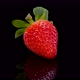 Perfect red strawberry rotating on a black background close up view. - VideoHive Item for Sale