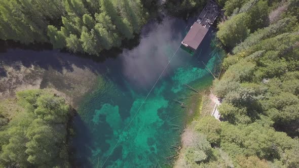 Aerial drone shot over crystal blue water of Kitch-iti-kipi, the big spring, in Palms Book State Par