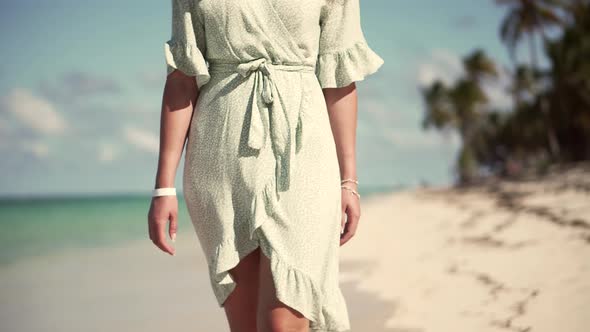 Woman Relaxing On Bahamas Flowing Dress Blowing In Wind. Travel Mood Wind Blows Dress On Ocean.