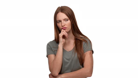 Portrait of Ginger Woman 20s Touching Chin and Thinking About Important Things or Doubting Isolated