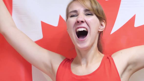 Canadian Young Woman Celebrating While Holding the Flag of Canada in Slow Motion