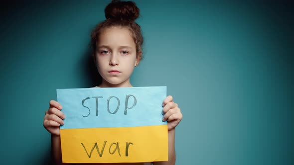 Upset Ukrainian Poor Toddler Scared Girl Kid Homeless Protesting War Conflict Raises Banner with