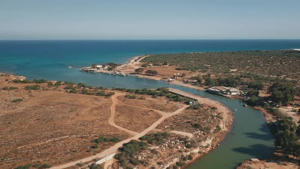 Sea Bay Water Flows in River in Dry Desert