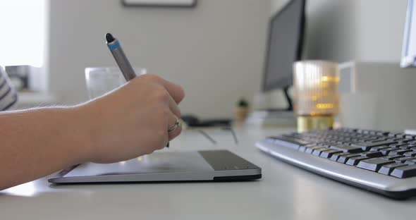 Closeup shot of Young hipster girl Working on Digital Drawing Tablet at His Desktop Computer. 