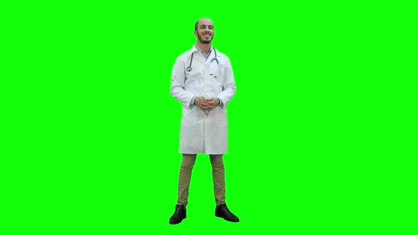 Smiling Doctor Happily Looking at the Camera on a Green Screen, Chroma Key