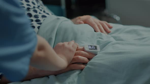 Elder Patient Getting Help From Nurse in Hospital Ward