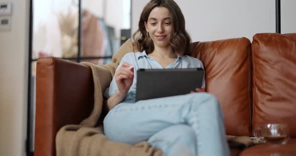 Female Artist Working on a Digital Tablet at Home