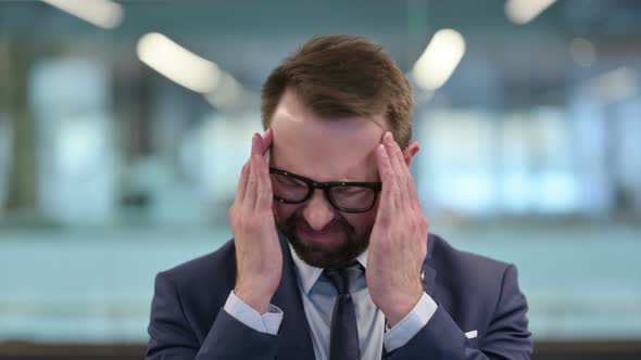 Middle Aged Businessman Having Headache