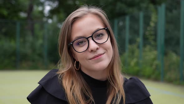 Portrait of Young Smiling Woman With Eyeglasses Looking at Camera, Close Up Full Frame