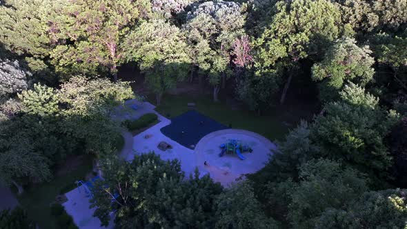 A high angle, aerial view of a park playground in the suburbs of Valley Stream, NY on a sunny day. T