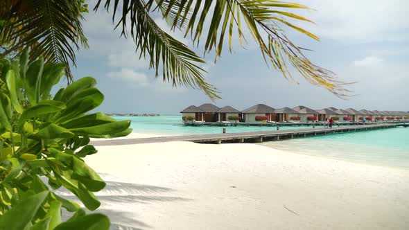 Luxury Overwater Villas on Turquoise Lagoon White Sandy Beach in Maldives