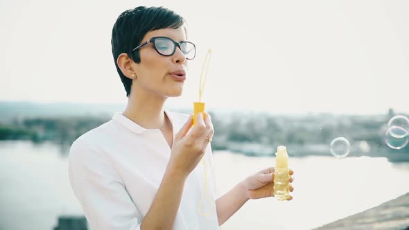 Beautiful Woman Blowing Dreamy Soap Bubbles