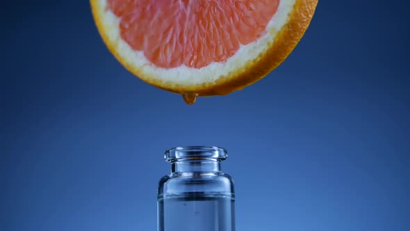 Grapefruit Oil Dripping Into Bottle