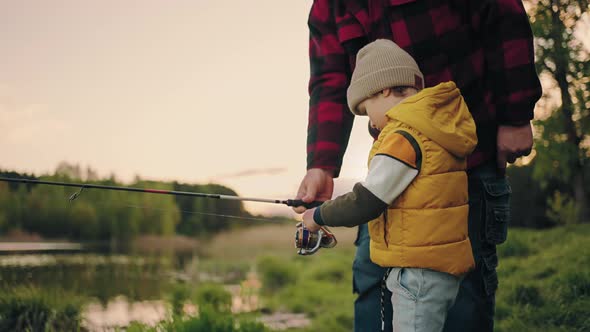 Cute Little Boy is Learning to Fish Granddad is Helping Him and Teaching Grandfather and Grandchild