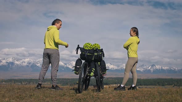 The Man and Woman Travel on Mixed Terrain Cycle Touring with Bikepacking