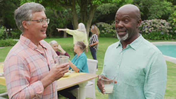 Animation of happy diverse senior male friends talking in garden